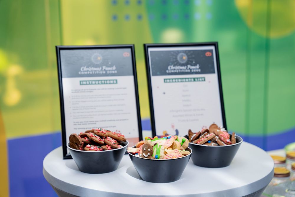 Corporate catering display with appetizers and food labels arranged on a modern serving station.