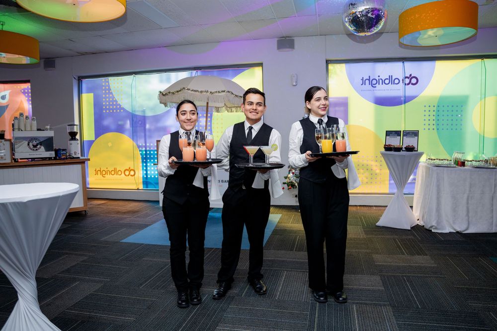 Corporate event space with modern branding displays and professional lighting setup showing presentation screens.