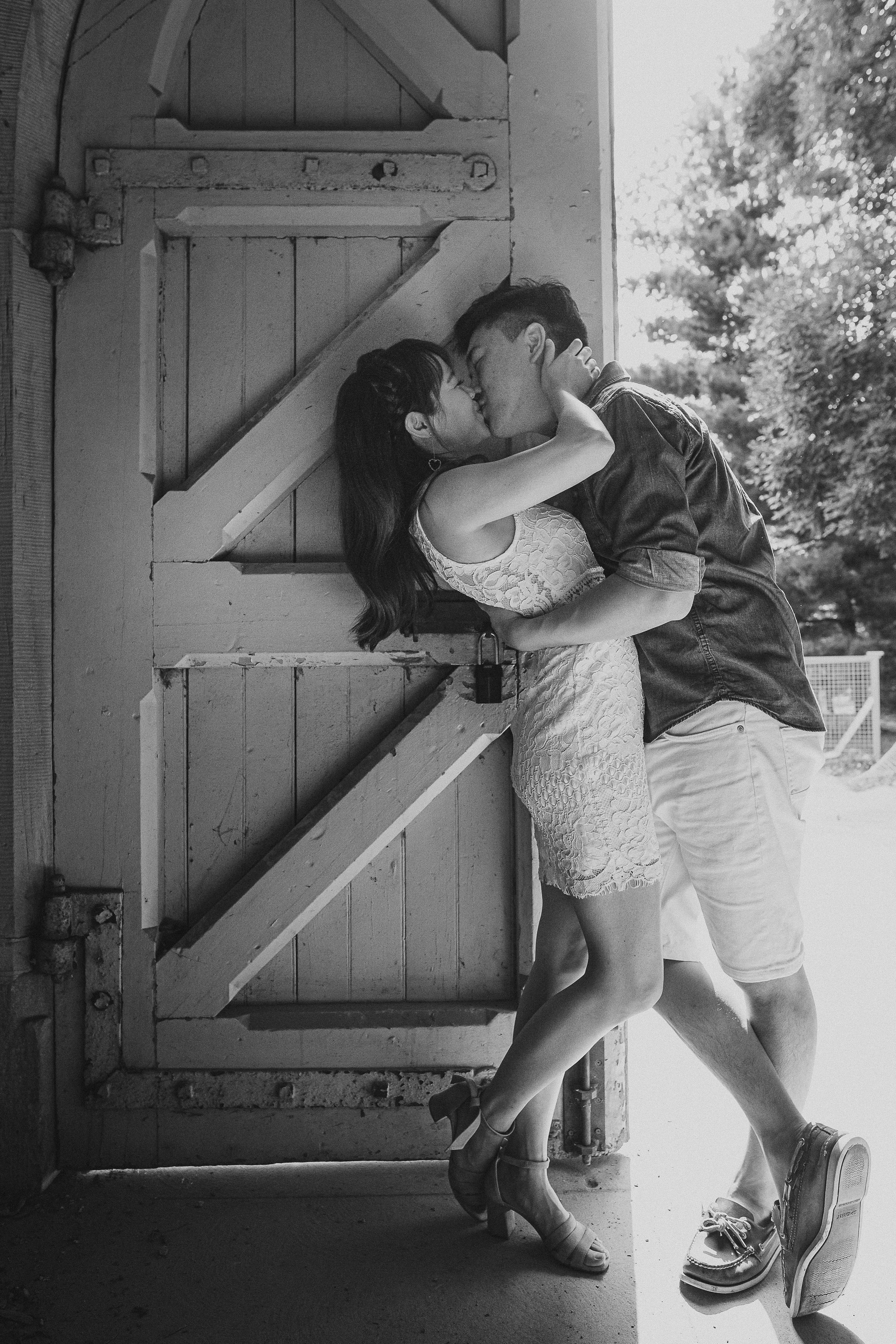 A playful black and white sequence shows a couple dancing and dipping against a rustic wooden door backdrop.