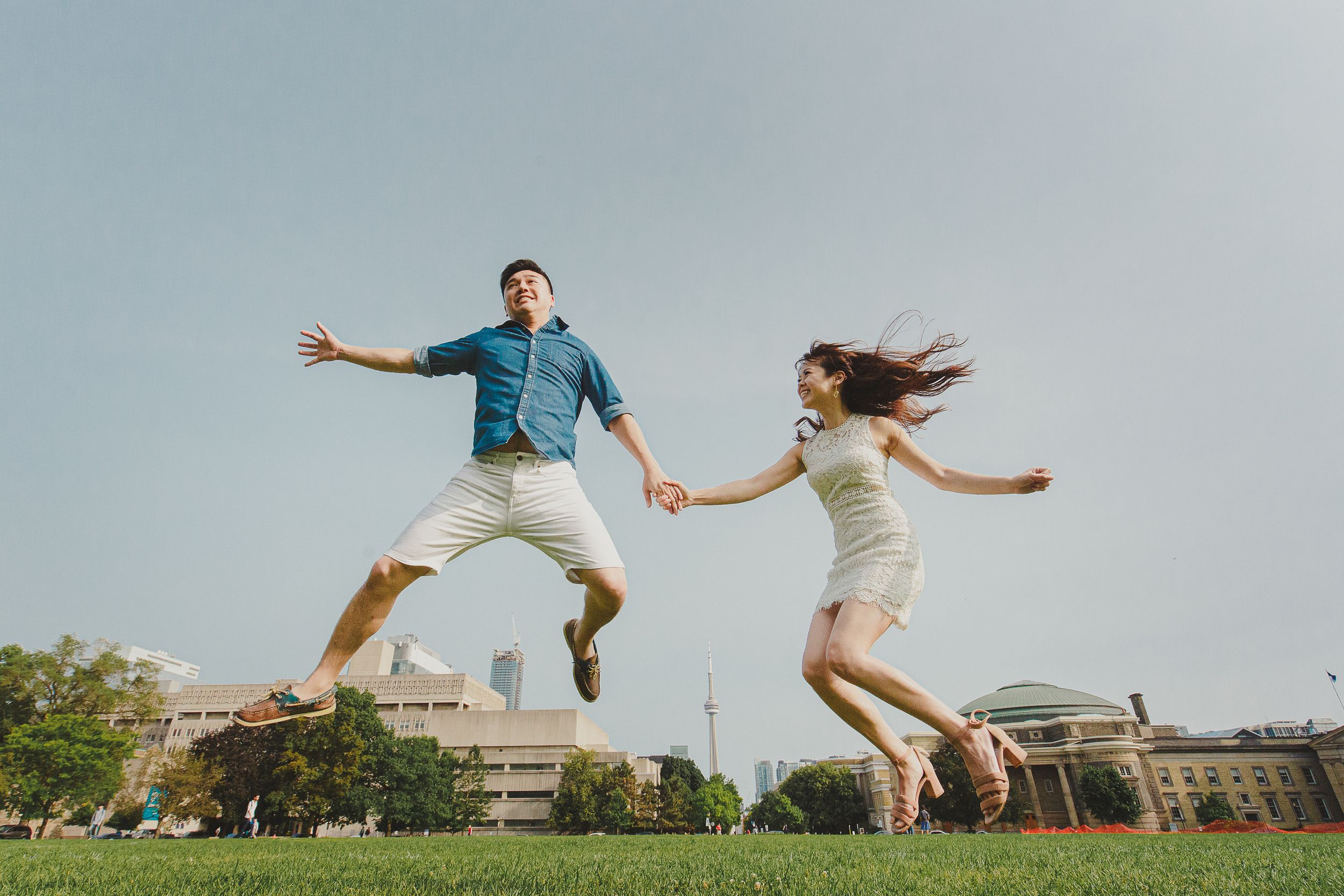 A series of dynamic jump photos showing people leaping joyfully in outdoor urban settings against a bright blue sky.