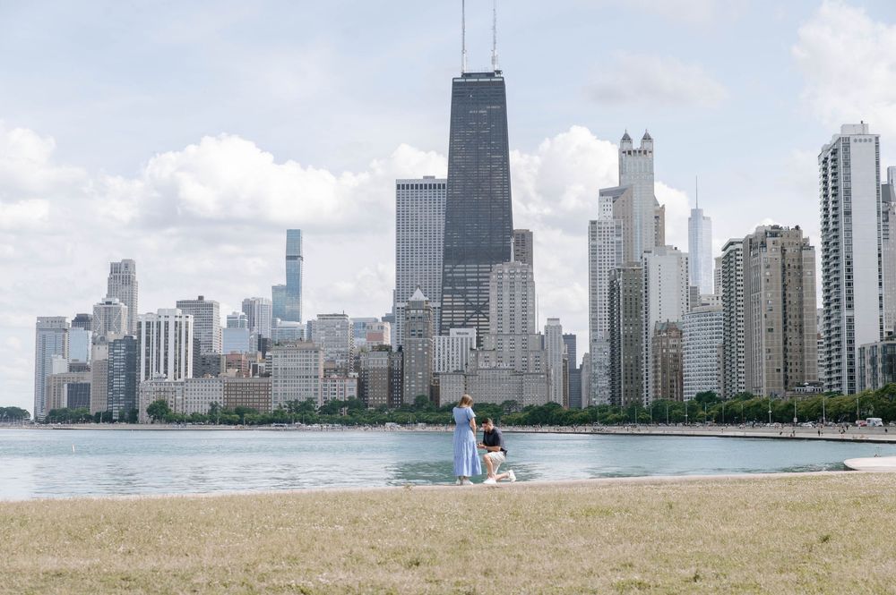 Panoramic view of Chicago's iconic skyscrapers and lakefront against a bright blue sky.