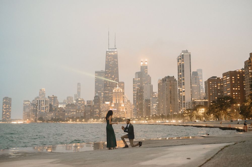 A romantic marriage proposal on Chicago's lakefront with the iconic Willis Tower skyline glowing at dusk.