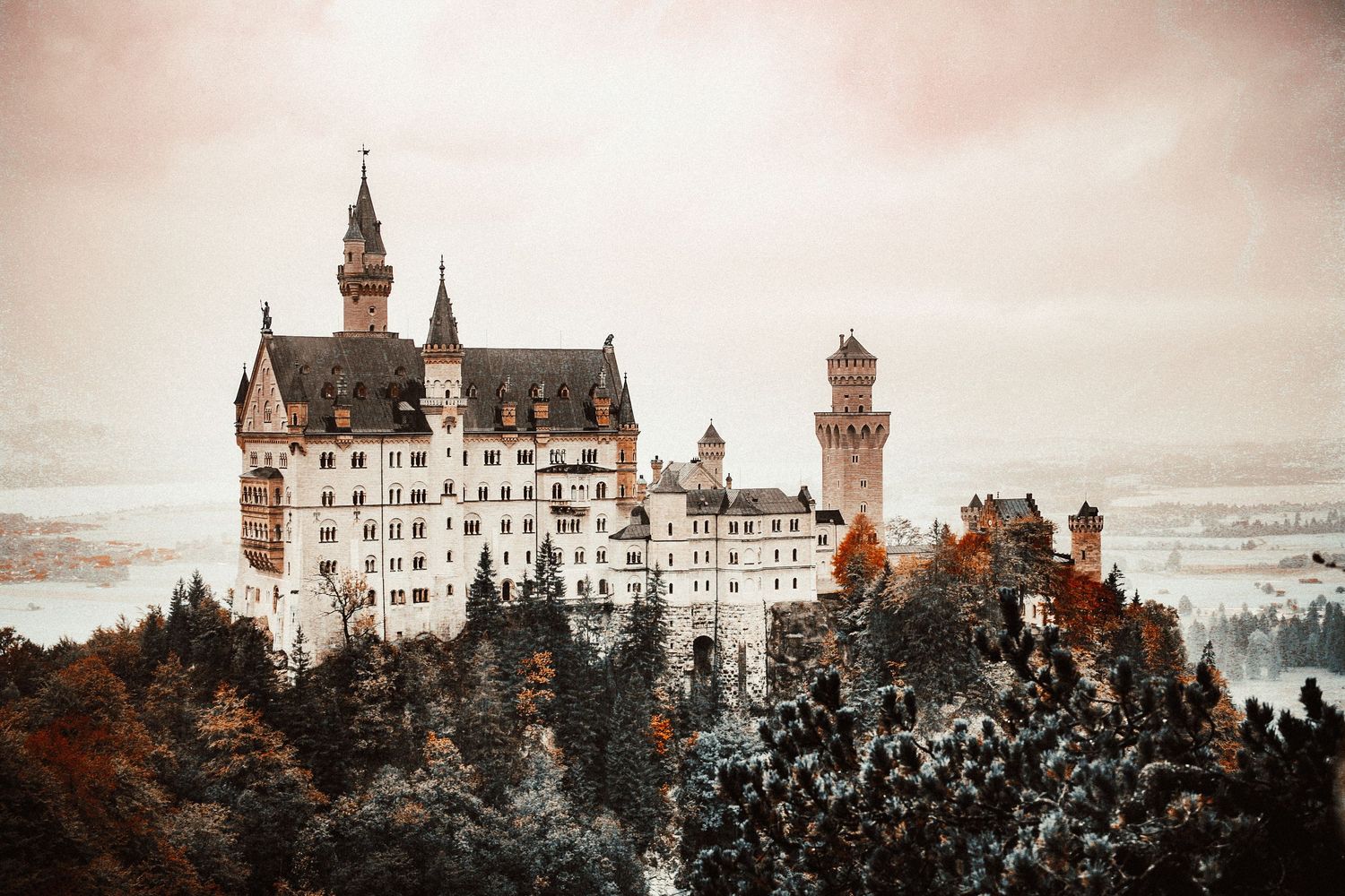 Seven sequential photos of Neuschwanstein Castle in Germany at different angles and lighting conditions show its iconic architecture.