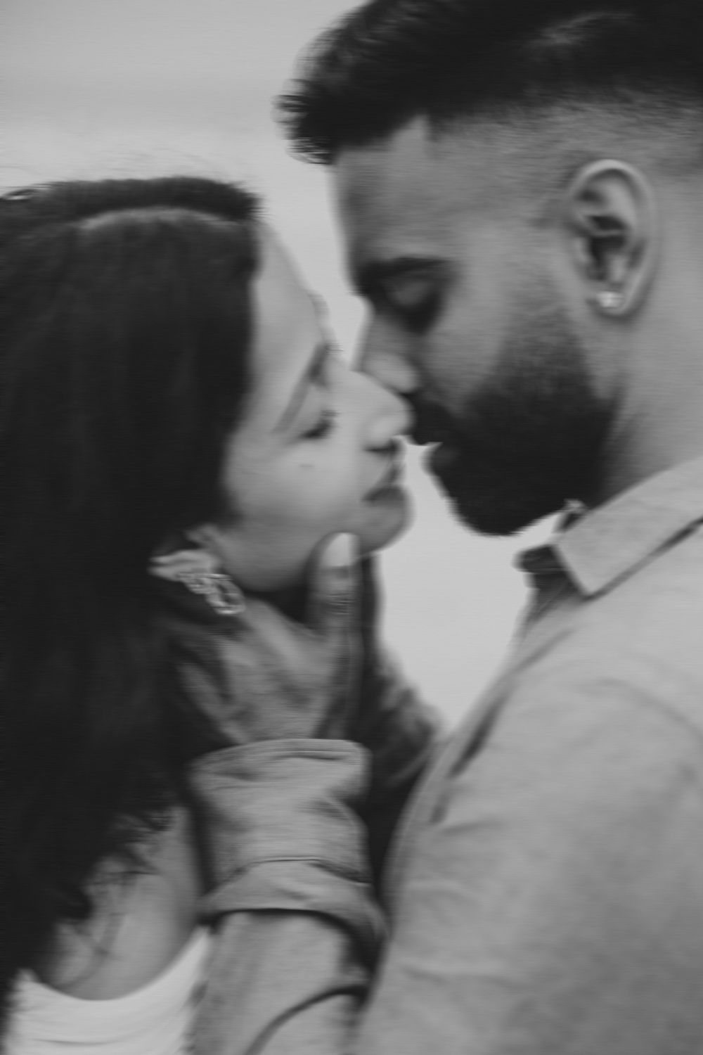 A romantic black and white sequence shows a close up of a couple about to share an intimate kiss.