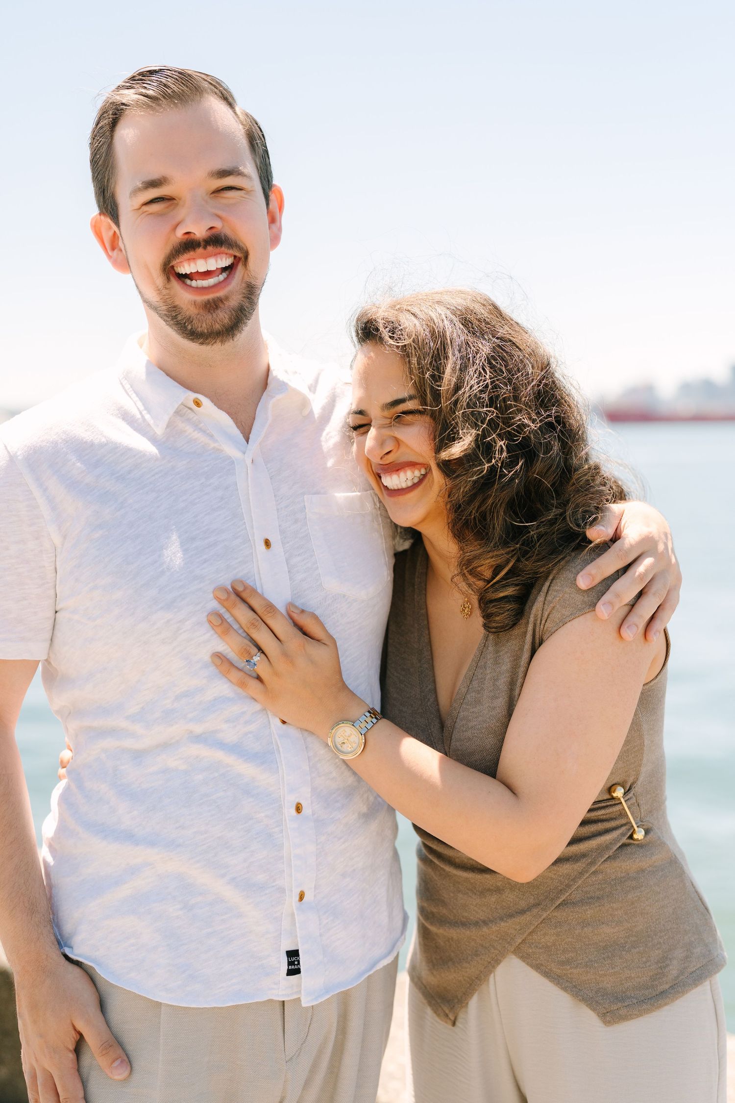 Happy couple shares joyful moments during a casual outdoor photo session.