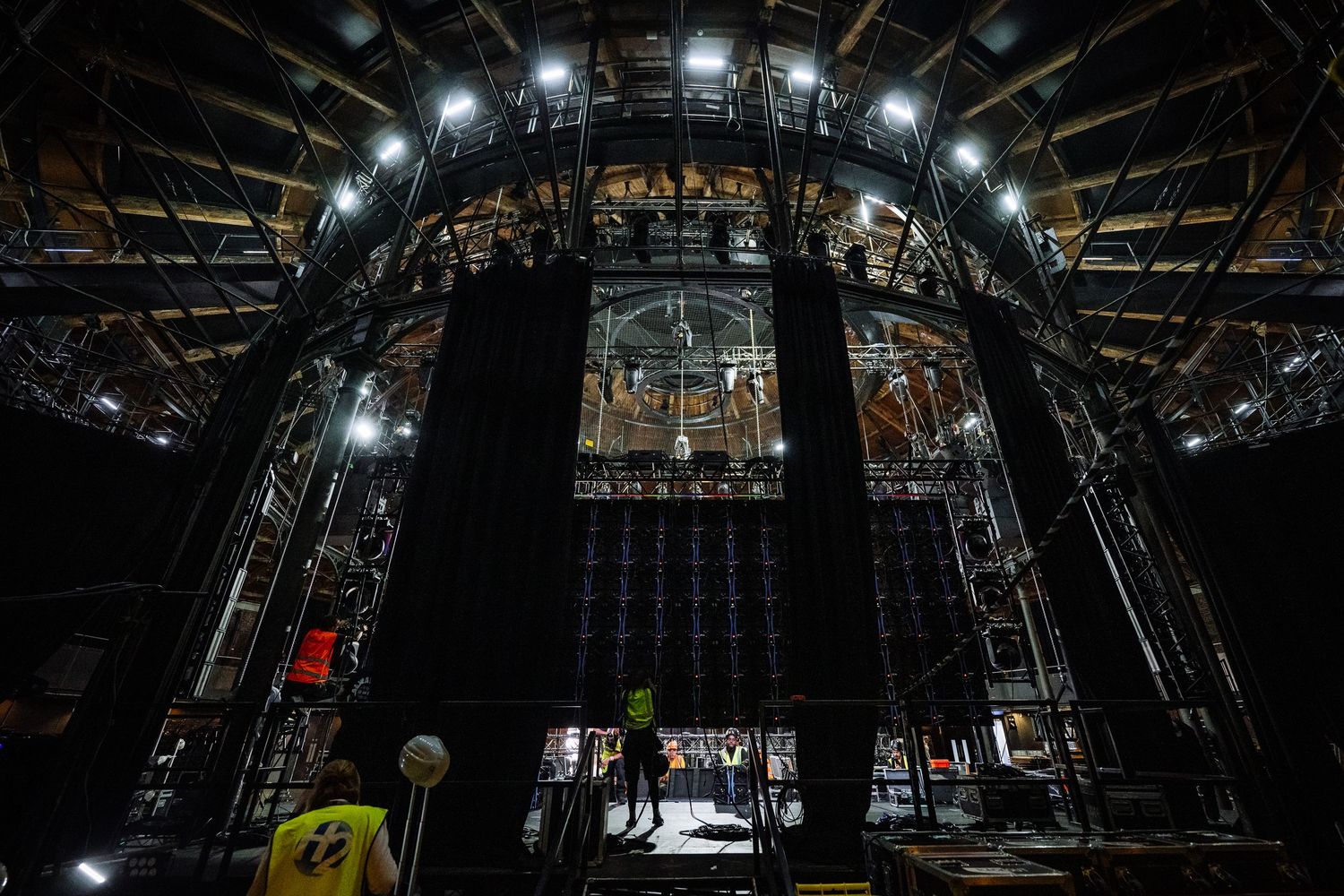 Theater lighting rig viewed from below showing complex technical setup and spotlights.