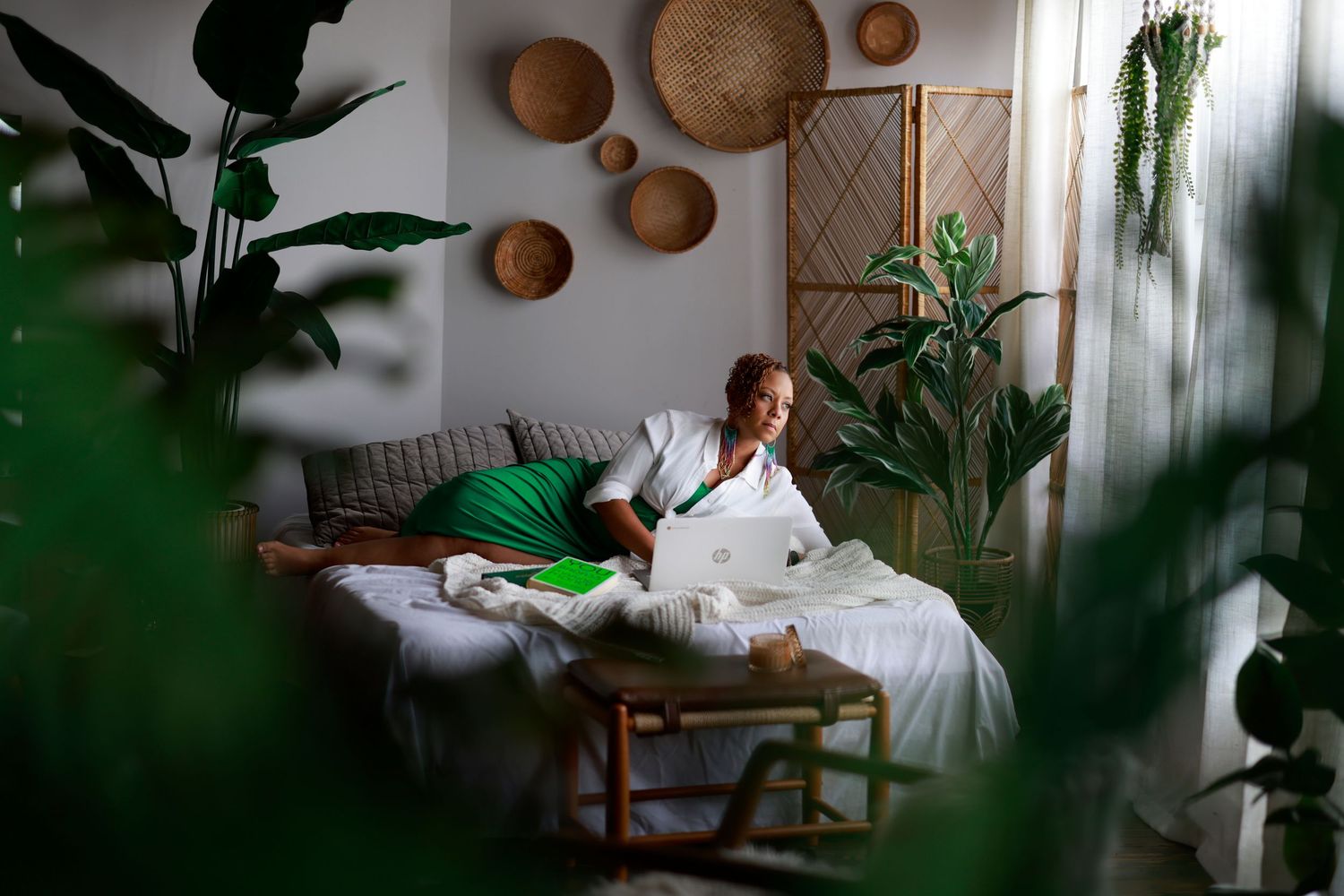 A collection of three interior photos showing a cozy boho-style living room with rattan decor, plants, and natural lighting.