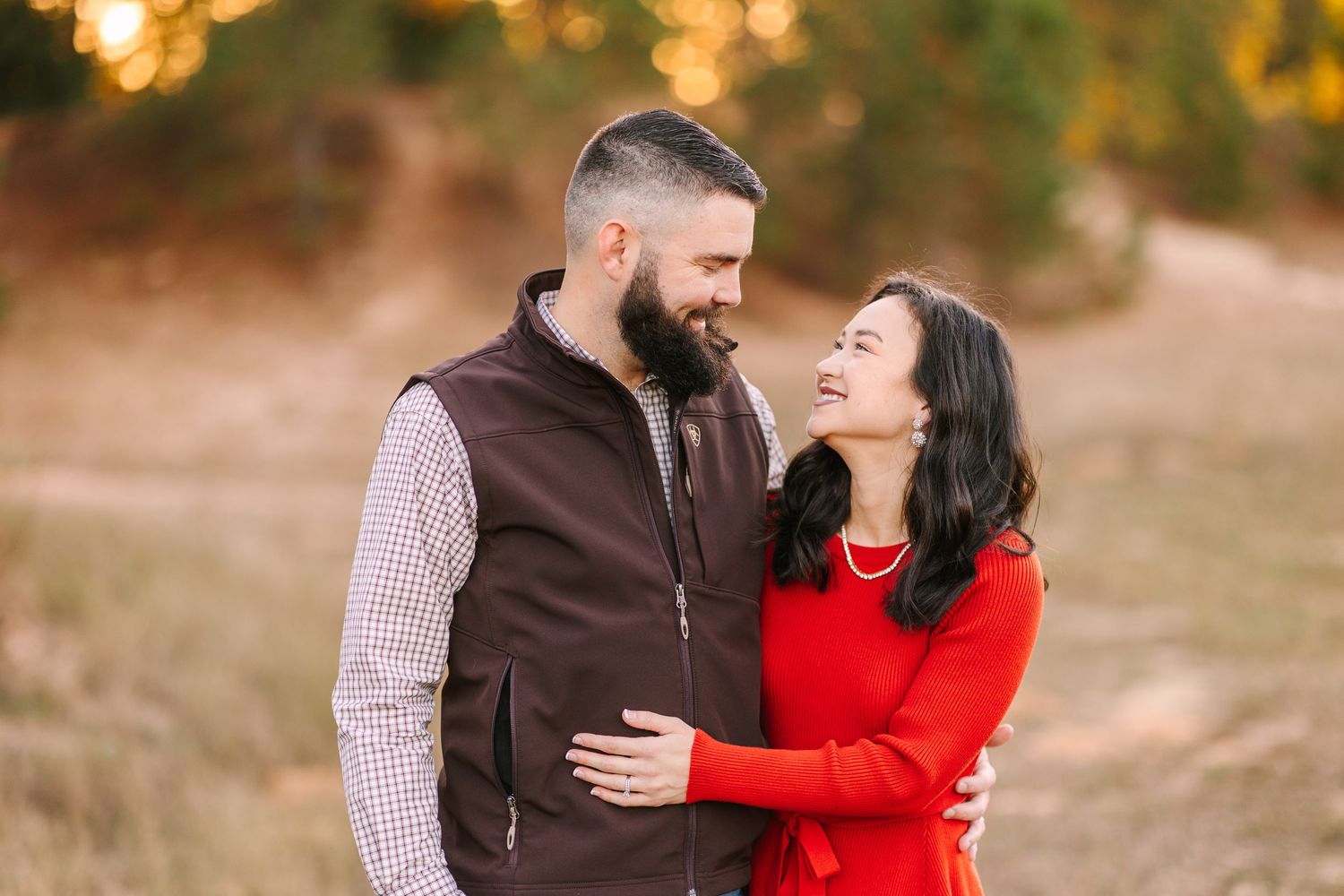 A heartwarming family moment captured during golden hour in a rustic outdoor setting.