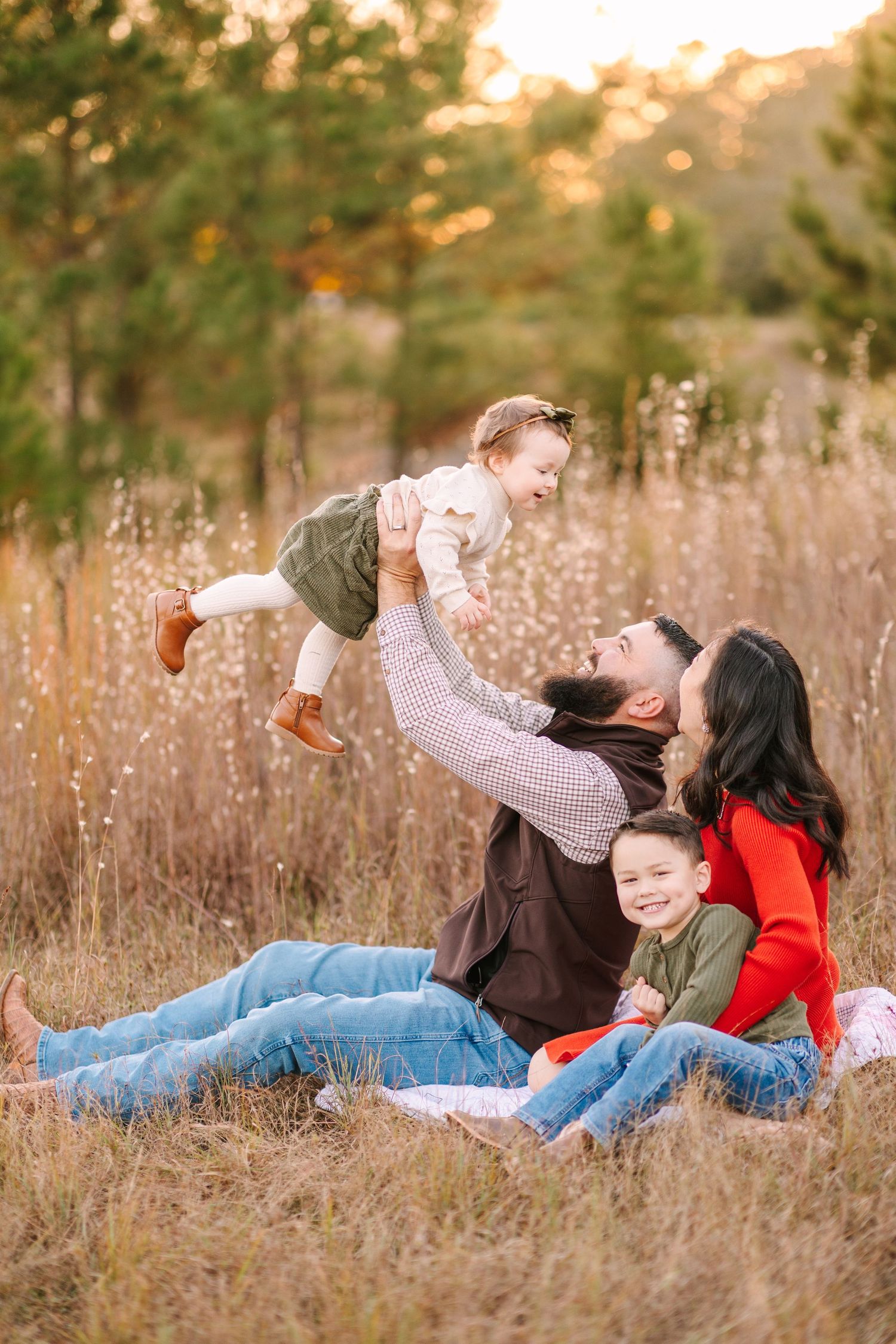 A playful photoshoot series in a golden field showing intimate family moments at sunset.