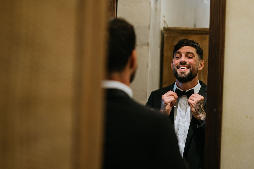 Wedding ceremony in elegant indoor venue with romantic lighting and classic decor.