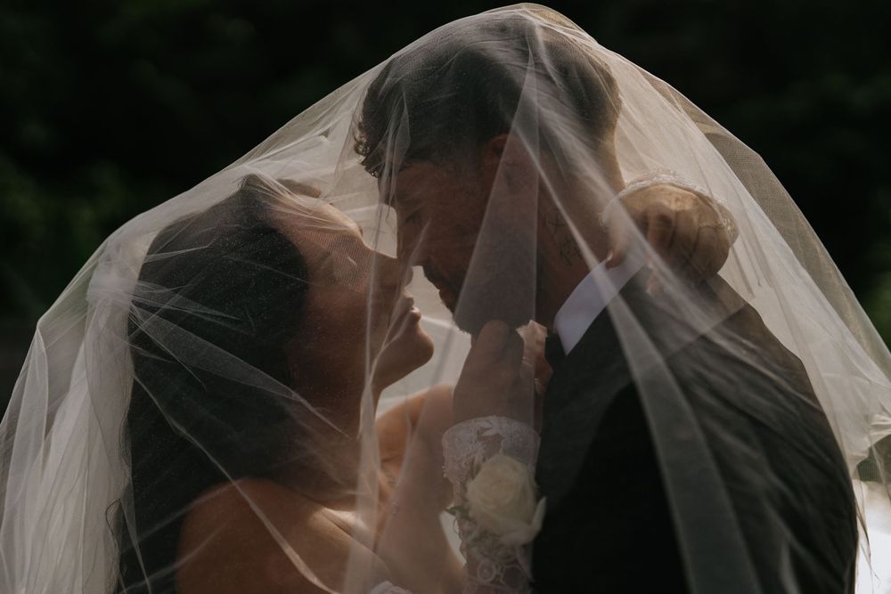 A romantic veil shot capturing an intimate moment during a wedding ceremony.