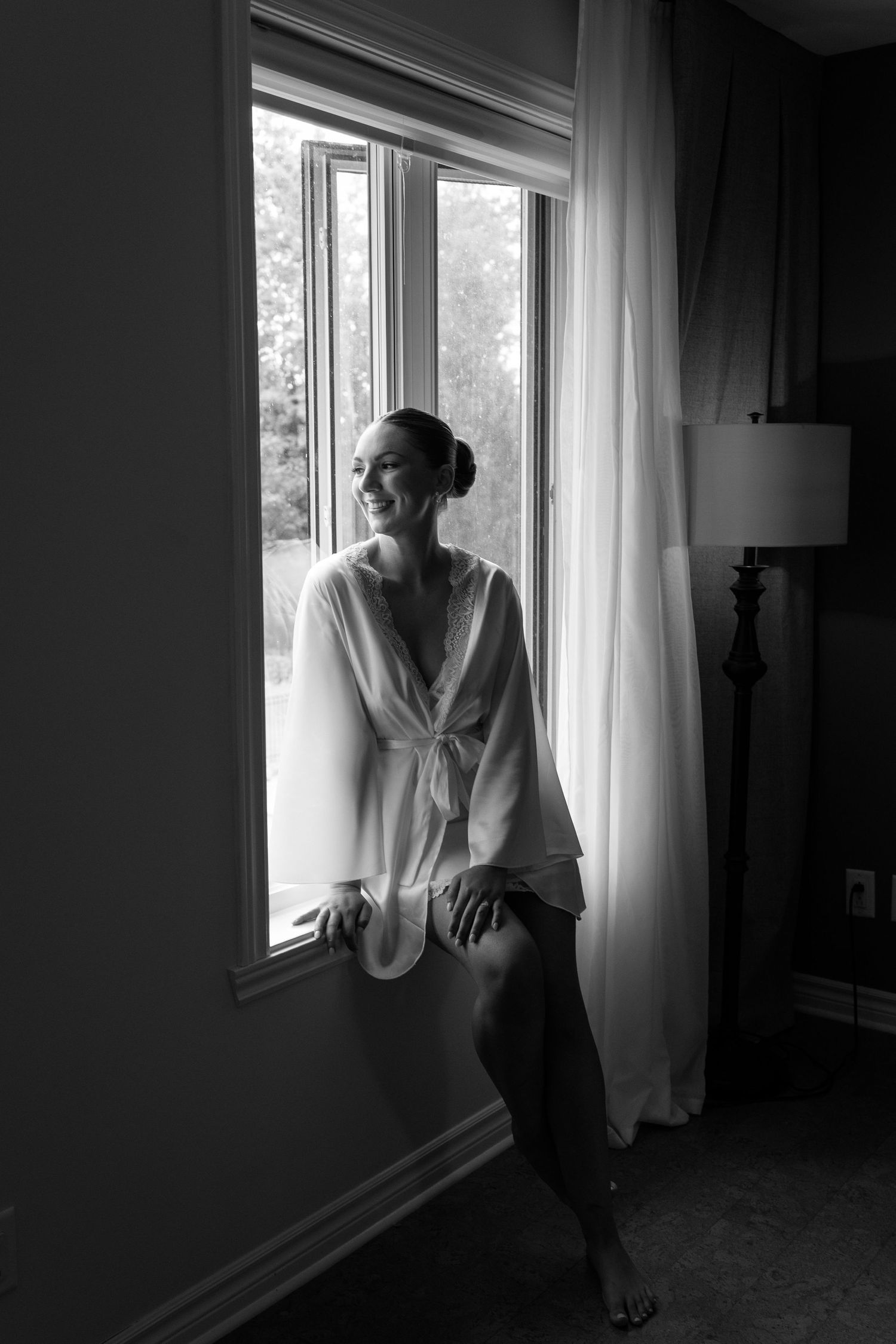 A moody black and white photo series shows a figure in white standing by a bright window with sheer curtains.