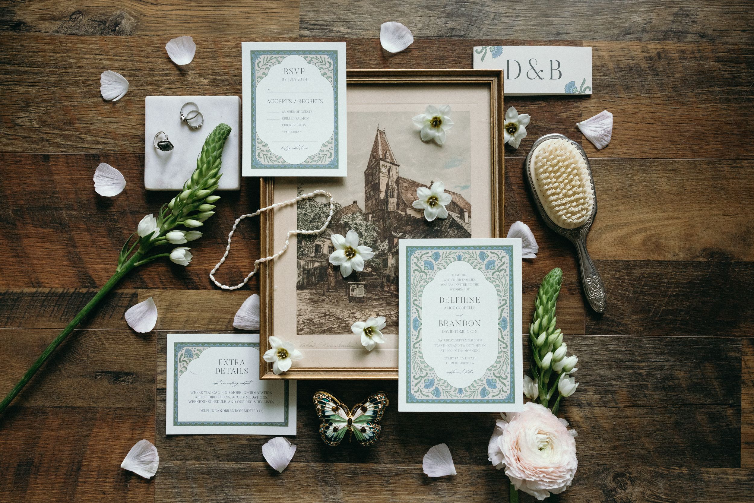 Wedding details and stationery artfully arranged on a rustic wooden surface with floral accents. Luxury Estate Wedding Photographer in NC