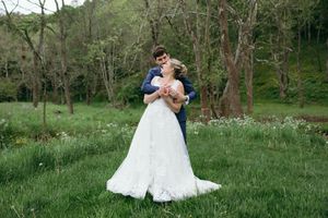 Romantic wedding portraits captured in green meadow surrounded by trees. Luxury Estate Wedding Photographer in NC