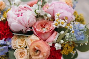 Delicate floral arrangement features pink peonies, roses, and blue hydrangeas. Luxury Estate Wedding Photographer in NC