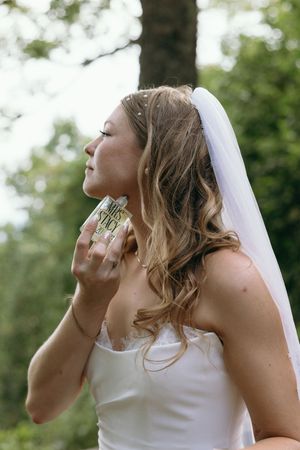Candid wedding moments captured outdoors with natural lighting and white veil details. Luxury Estate Wedding Photographer in NC