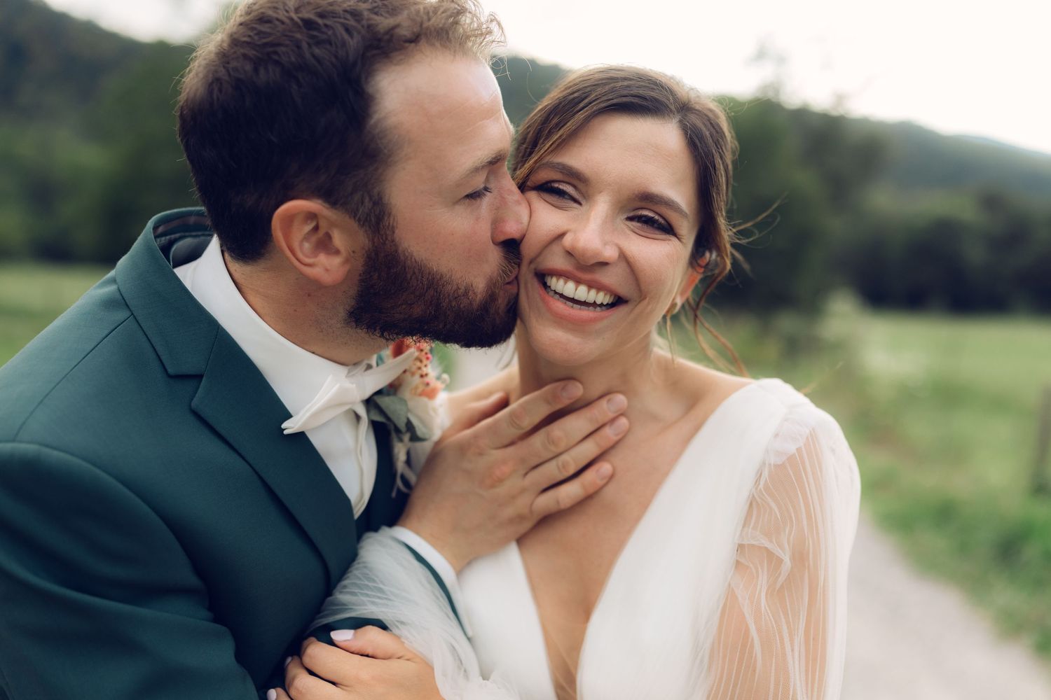A romantic wedding moment captured between newlyweds in an outdoor setting.