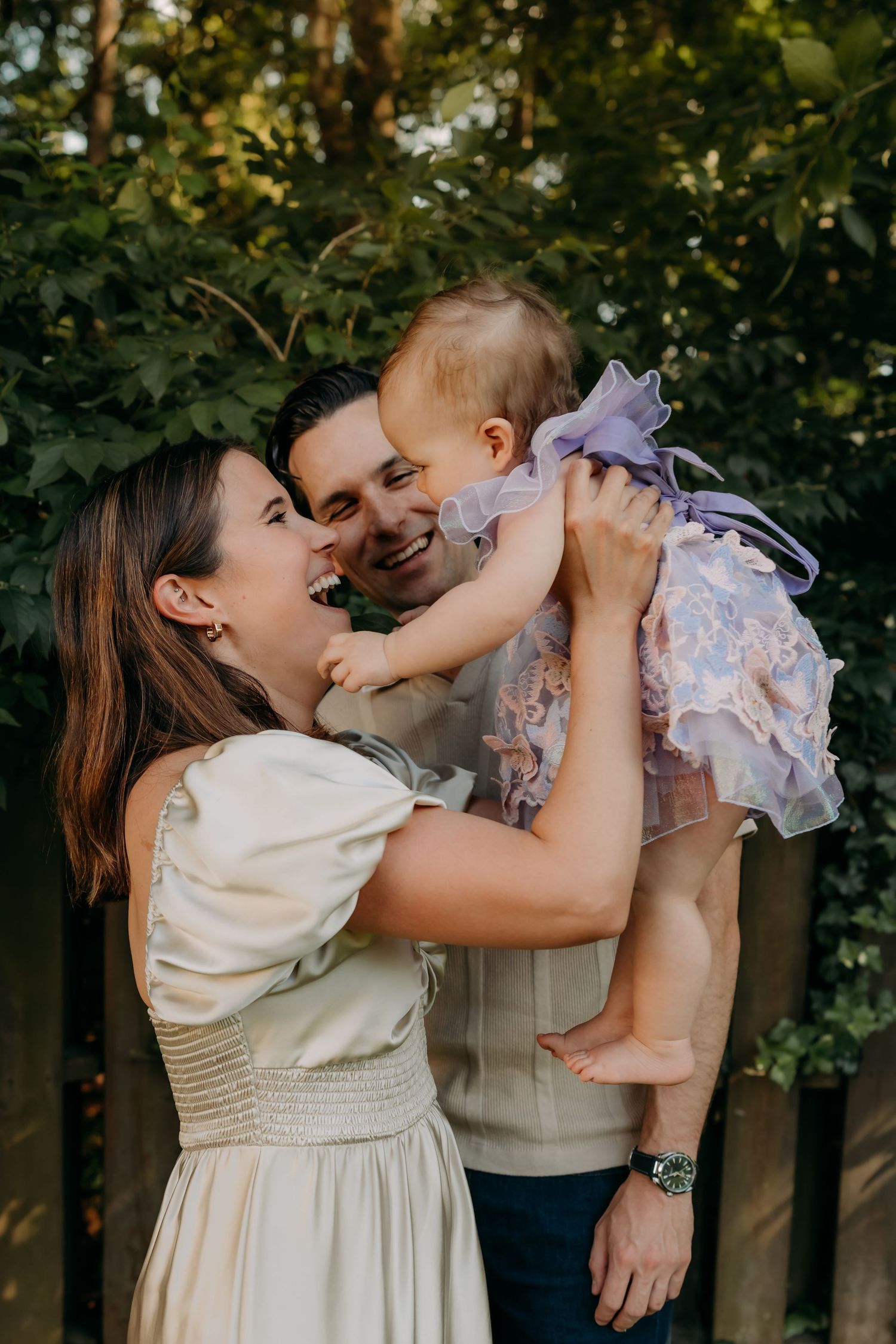 An intimate family moment captured in a series of portraits showing playful interactions between parent and baby outdoors.