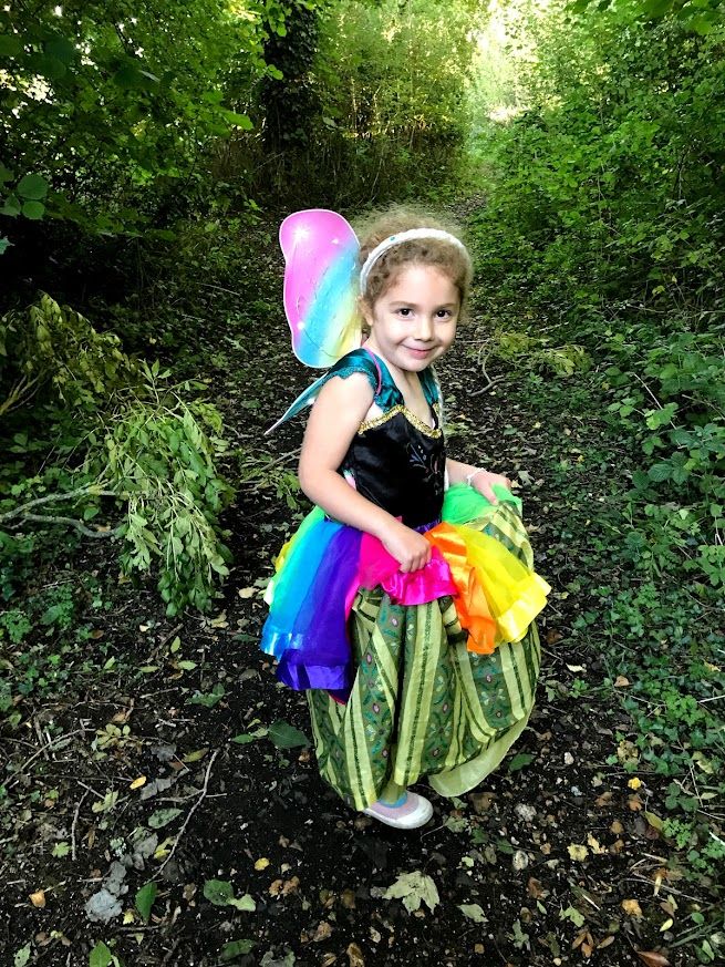A sequence of photos showing a young person in a fairy costume exploring a wooded area with vibrant green foliage.