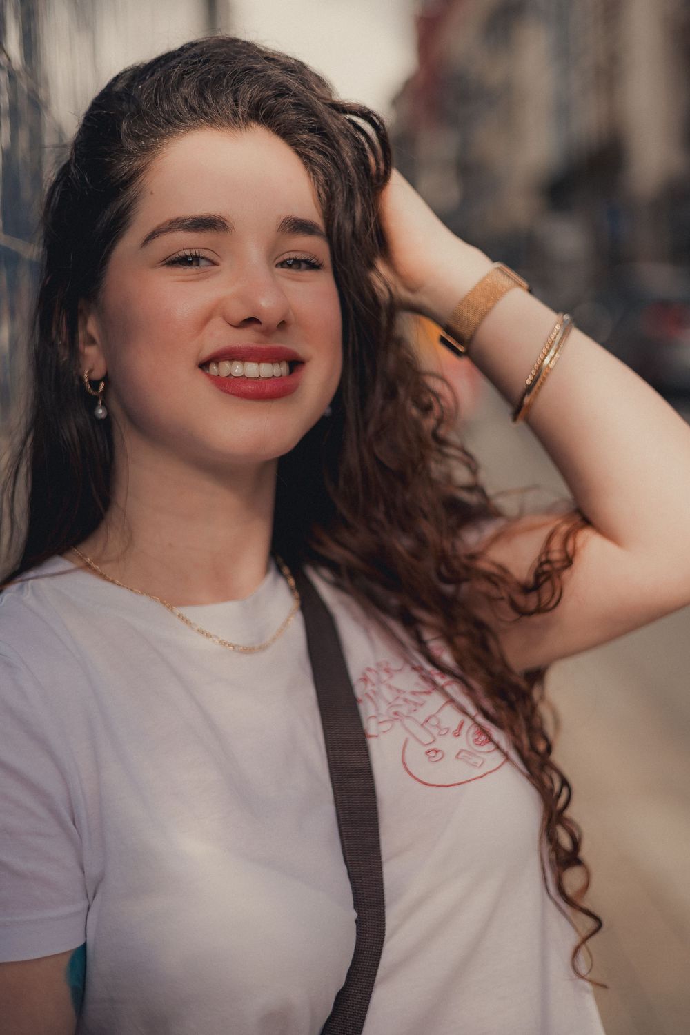Casual portrait series showing expressive poses in white shirt against city street.