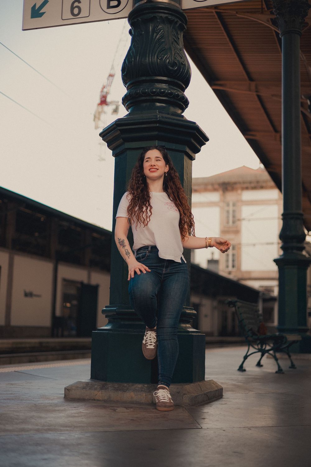 Urban portrait by decorative iron lamppost at railroad station.