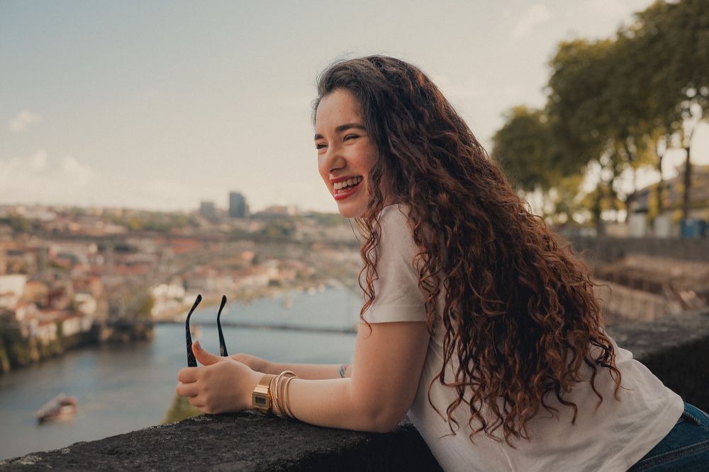 Scenic portrait overlooking Porto cityscape and river during sunset.