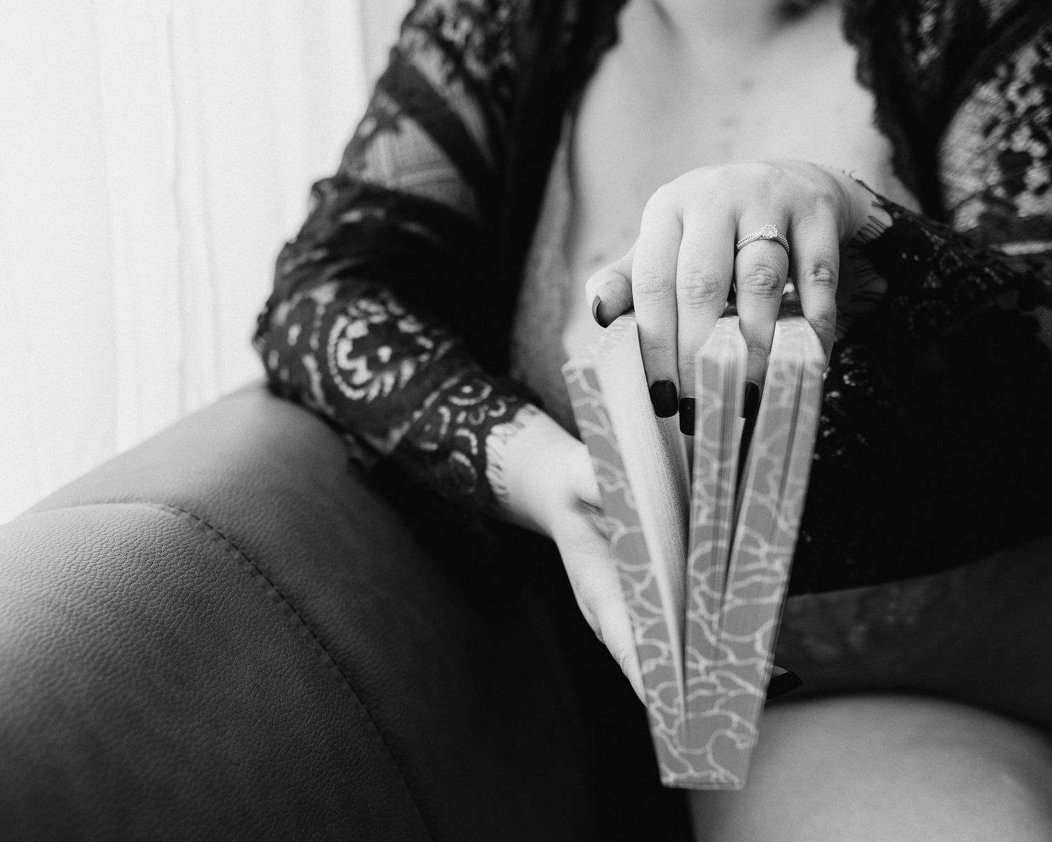 Professional boudoir photo of a woman holding a book