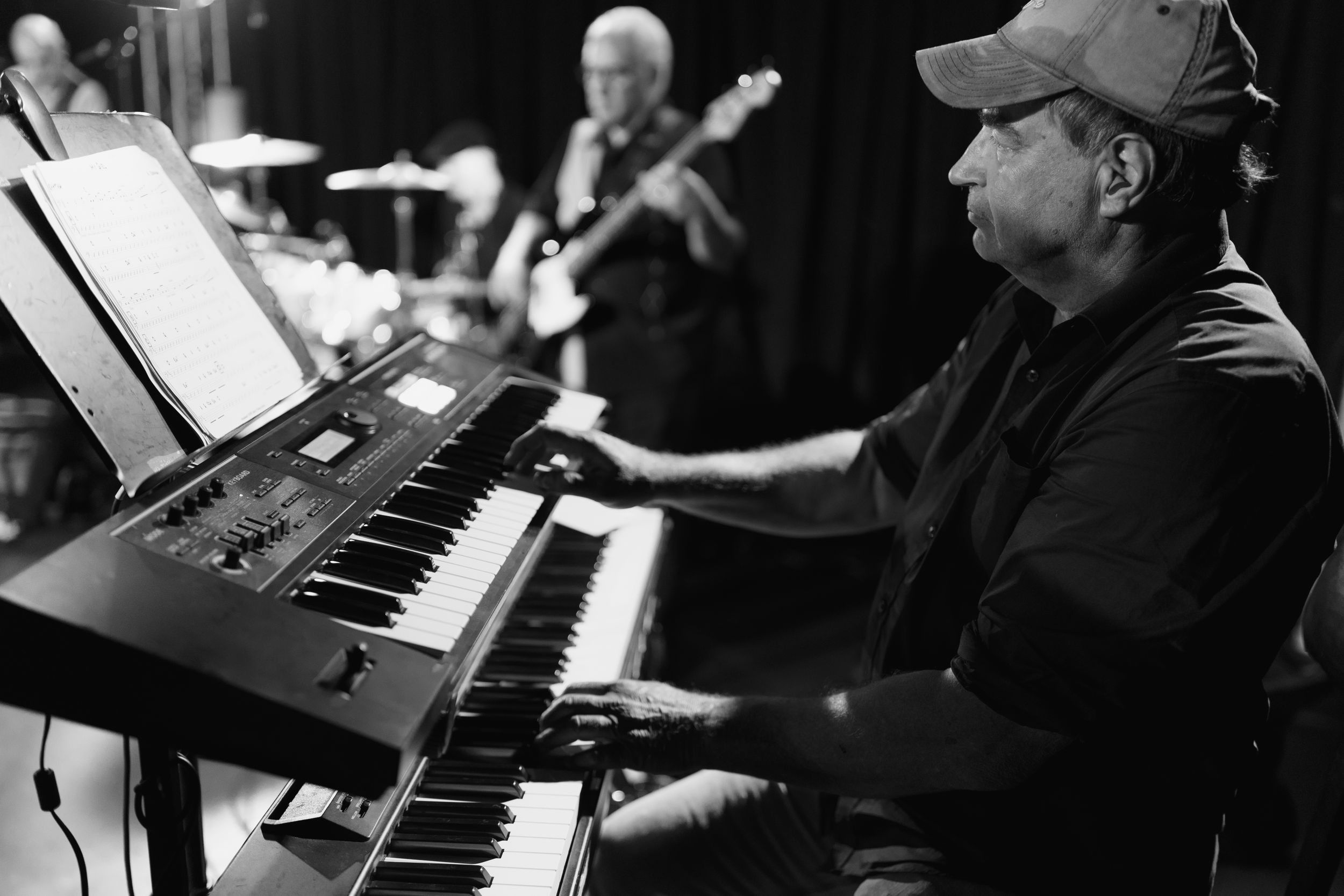 A series of black and white photographs showing close-up shots of pianists performing at their instruments.