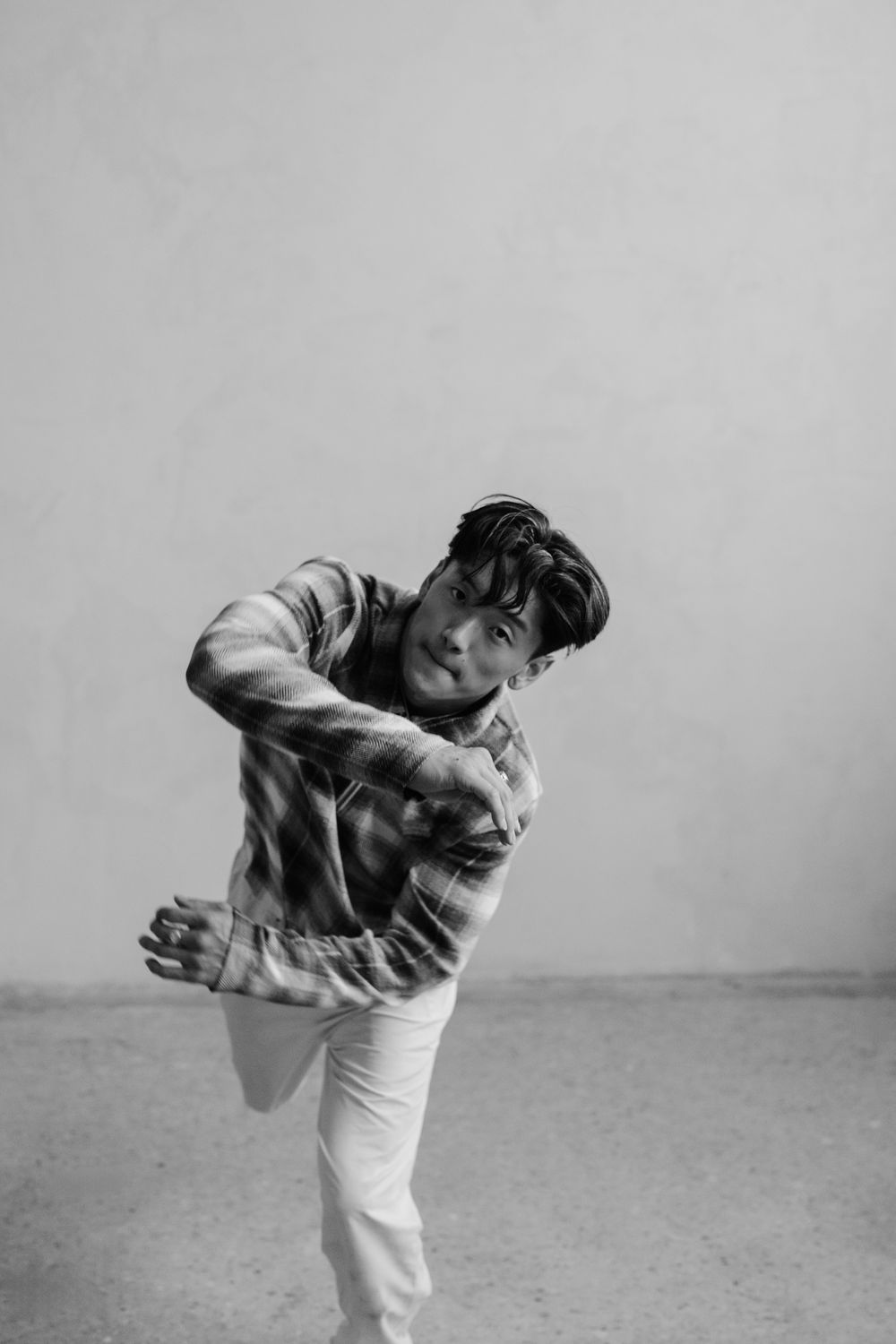 Dynamic black and white photo series showing martial arts movement sequence with figure in white pants and dark top.