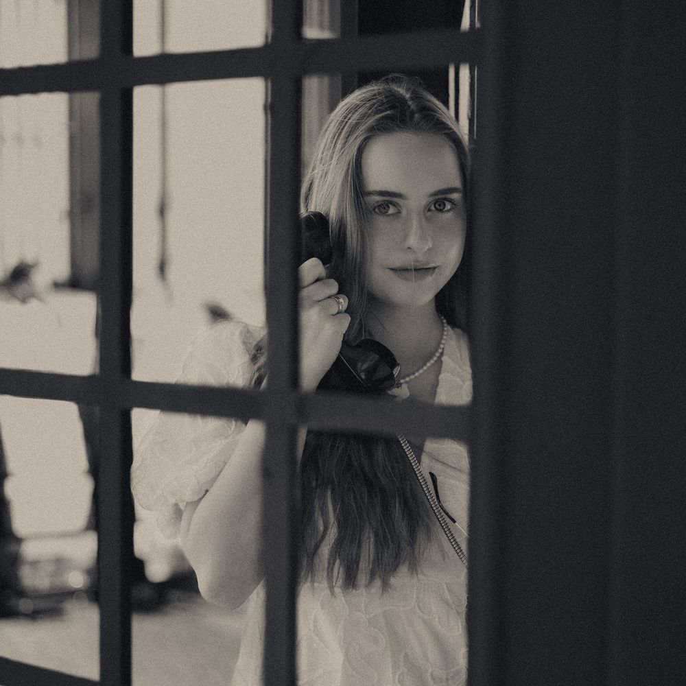 Artistic black and white portrait through window panes.
