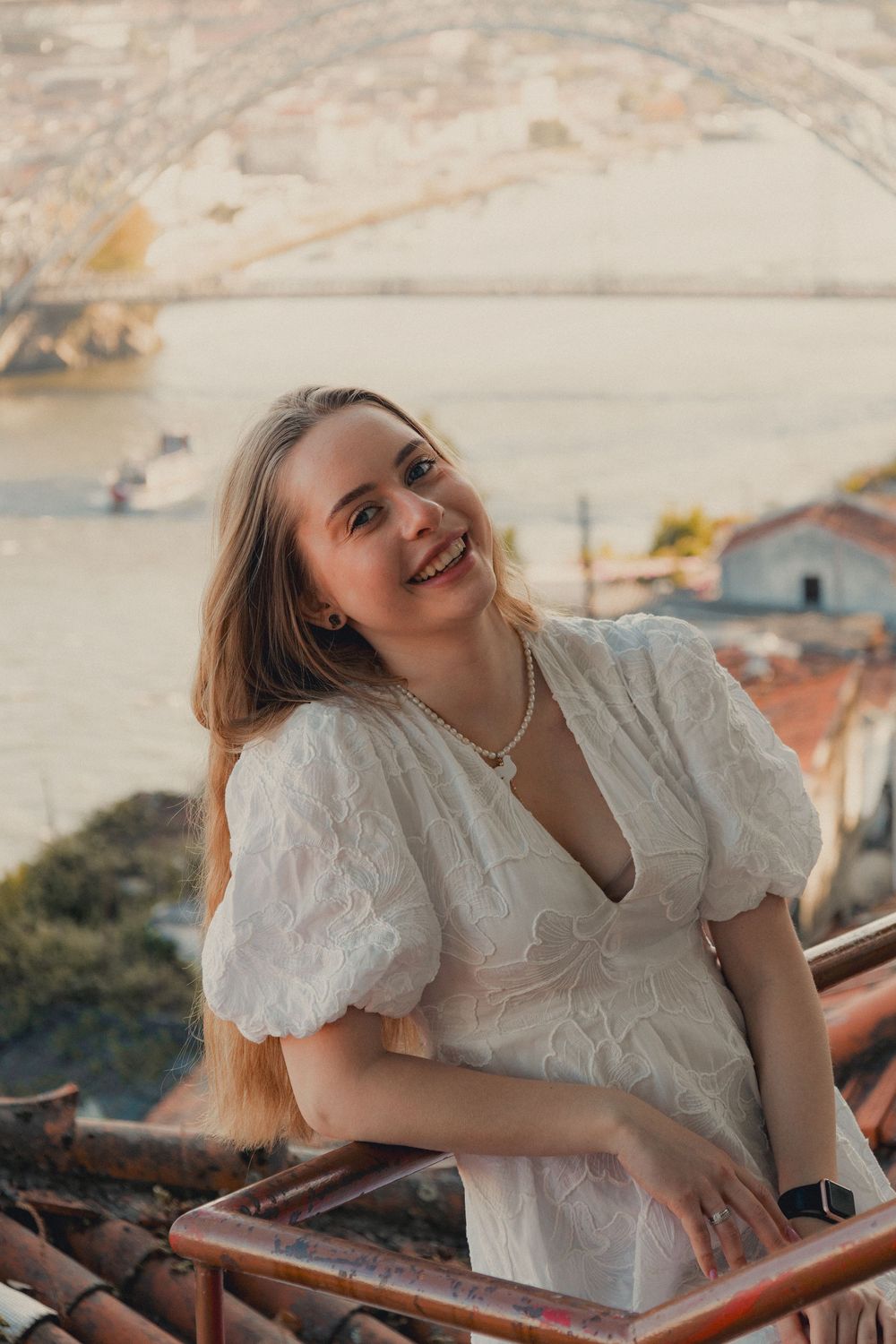 Joyful moment captured on rooftop overlooking river and city landscape.