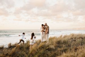 Coastal landscape panorama with grass and ocean waves at golden hour.