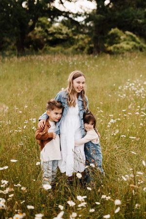 Family sharing joyful moments in field of wildflowers.