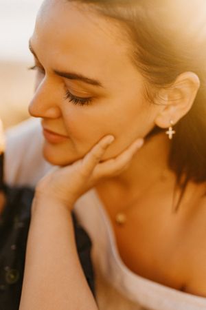 Soft focus portrait with gentle sunlight creating a warm, dreamy atmosphere.