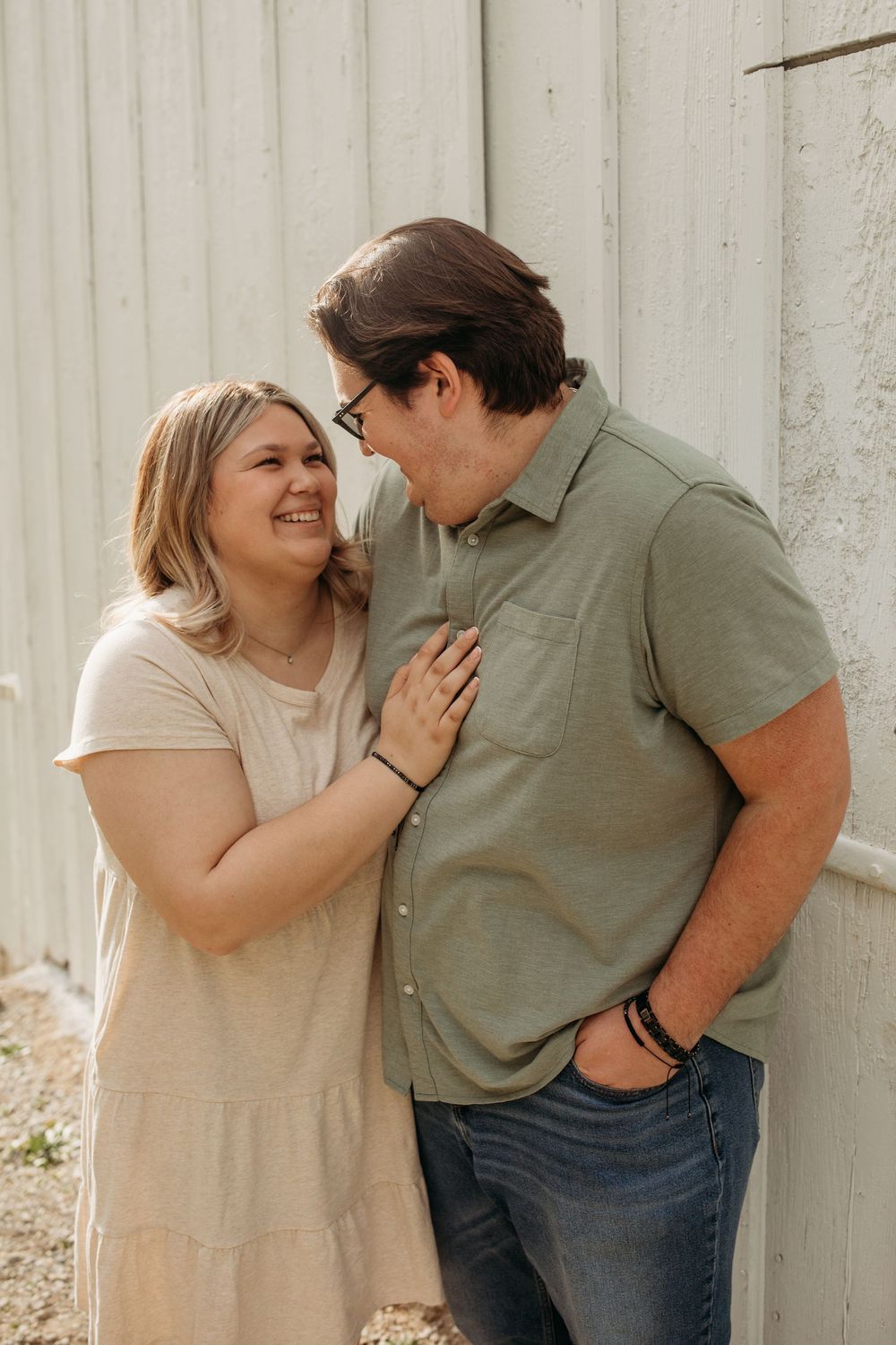 Candid moments of laughter and joy between people against a white wall background.