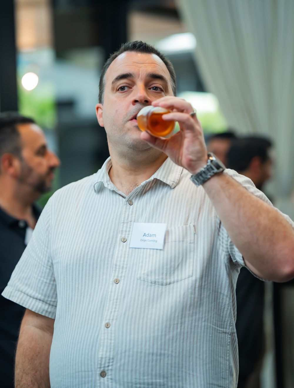 A series of sequential photos showing someone in a white striped shirt drinking from a glass with increasing angles.