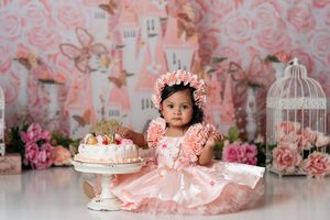 Romantic pink floral backdrop with castle design and vintage birdcage decorations.