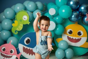 Colorful baby shark birthday party setup with balloons and sea-themed decorations.