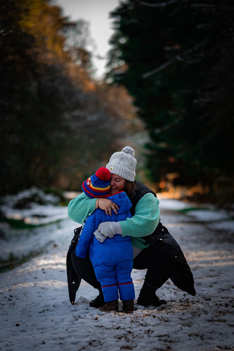 Mother and child or son, embracing in the snow, by Poole, Bournemouth and Dorset wedding photographer "kris the photographer"