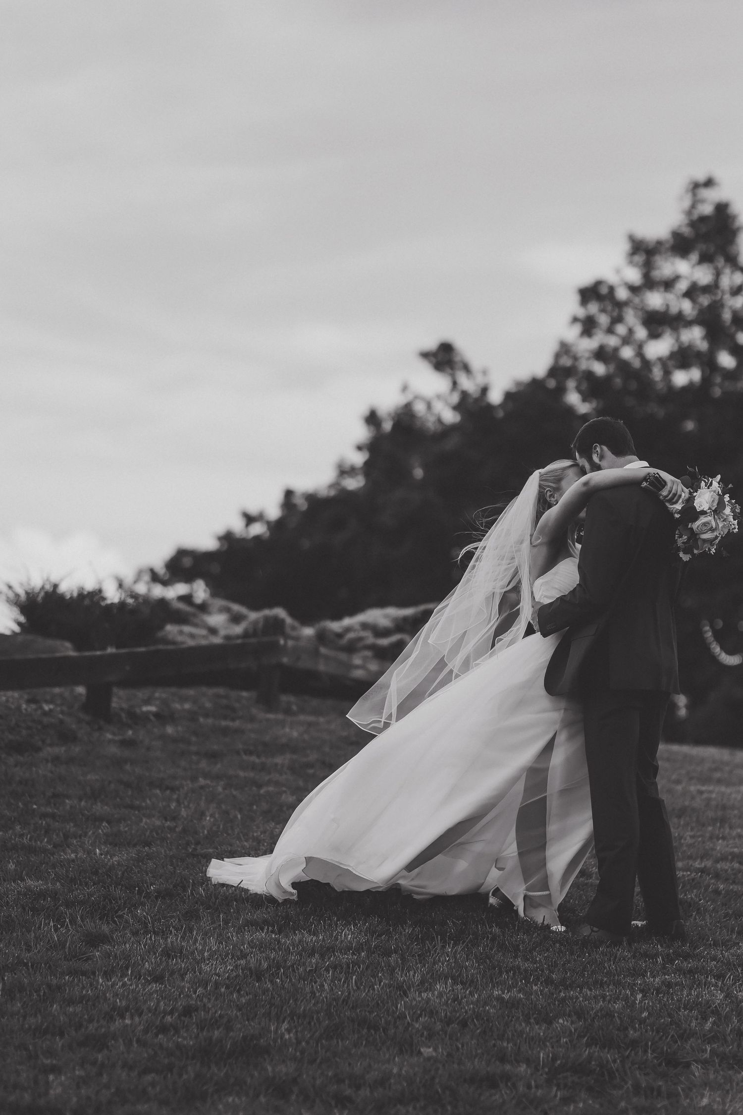 A sequence of black and white photos showing joyful guests celebrating at a wedding reception gathering.