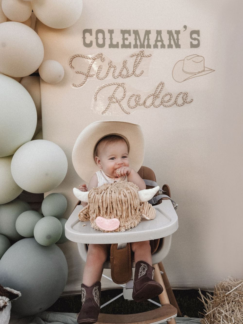 Western-themed first birthday party setup with balloons and rustic decorations.