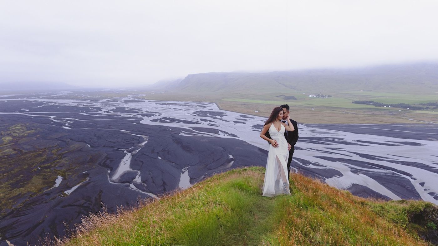 Couple standing in front of braided rivers.