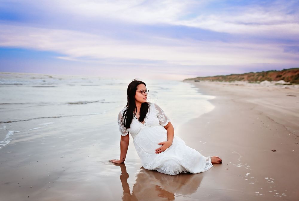 Mama posing on beach during maternity session