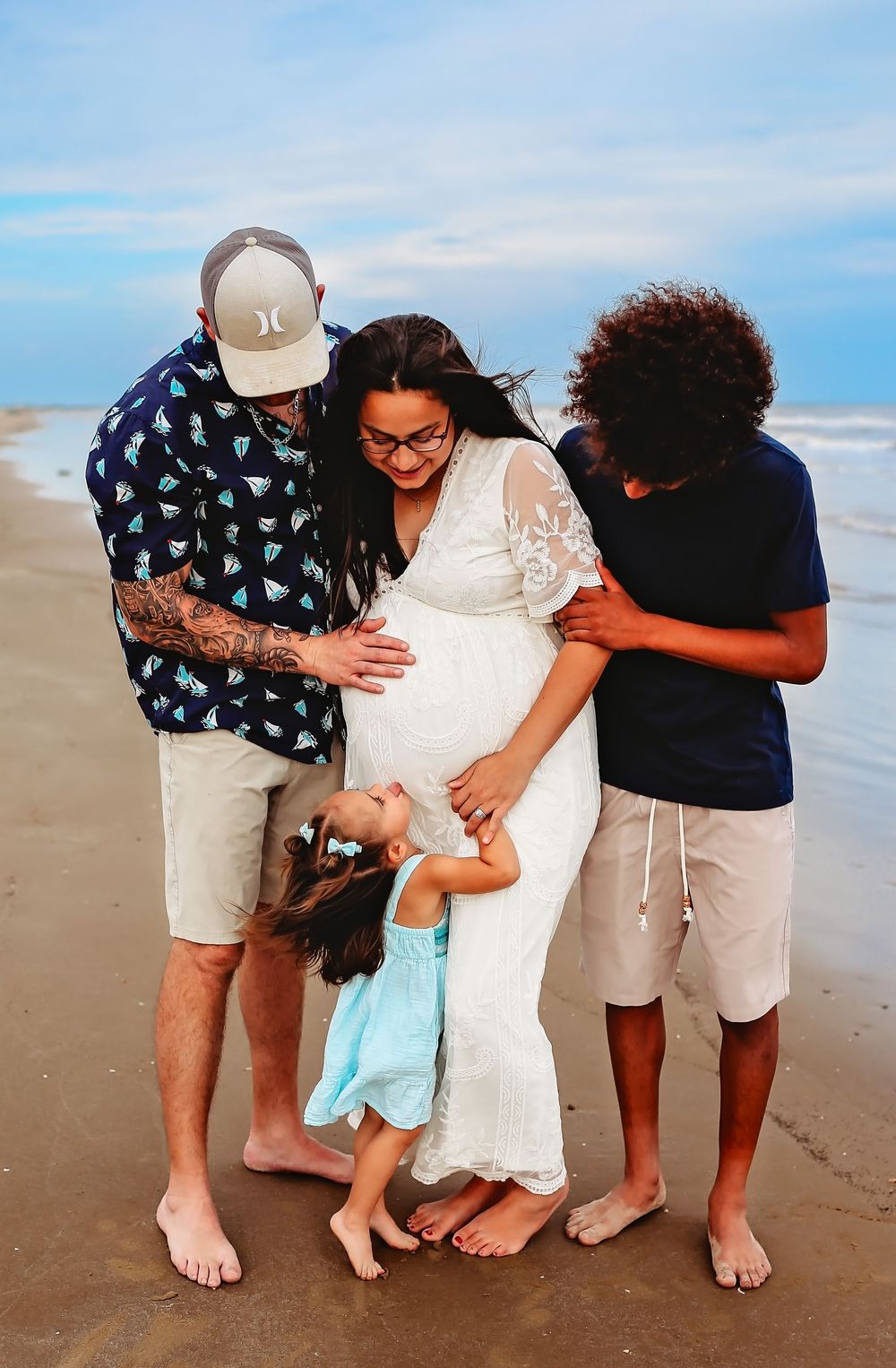Family on the beach during maternity session