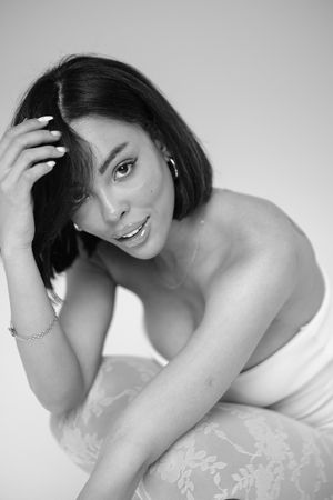Intimate black and white portrait with soft lighting and delicate lace details.