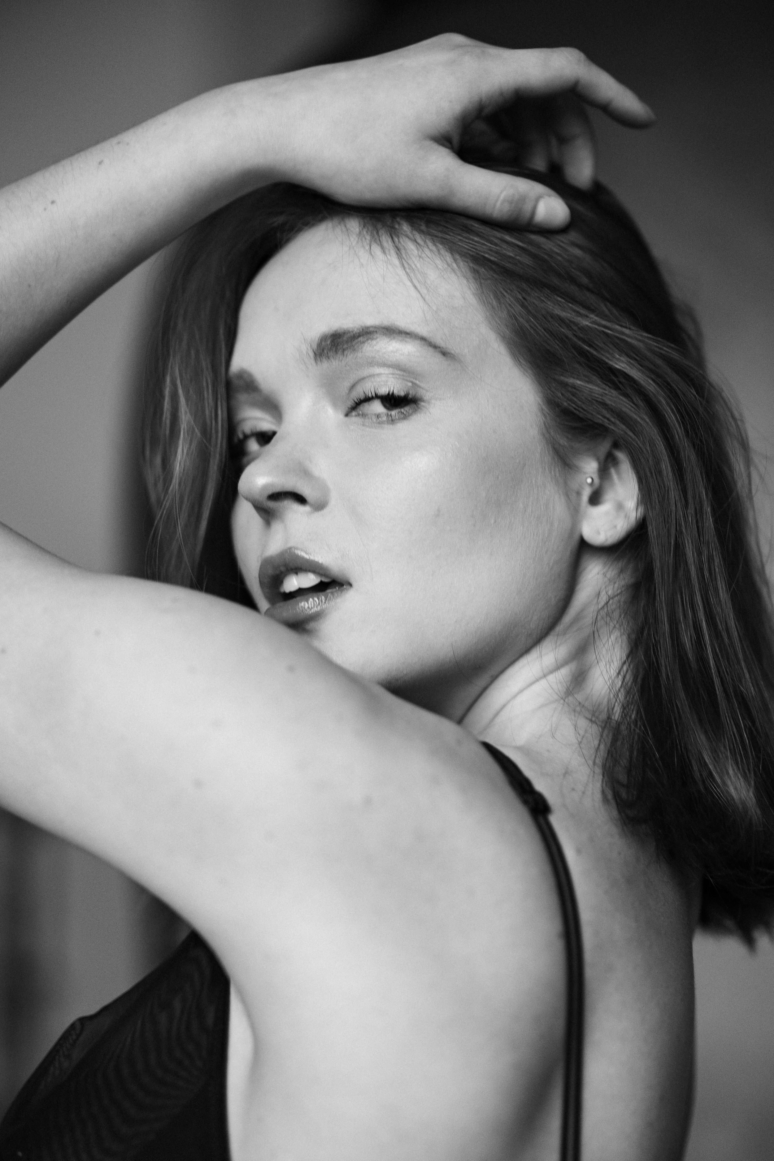 Black and white portrait series showing graceful poses and dramatic angles.