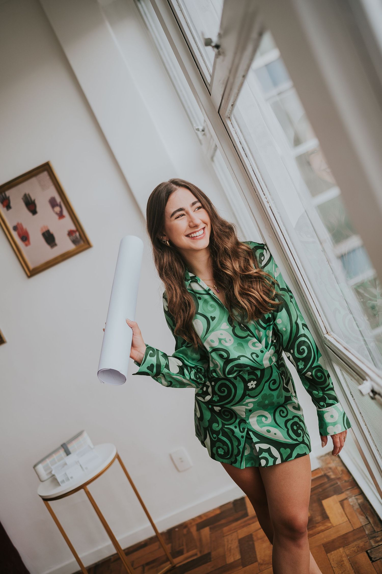 Dynamic fashion shot in green patterned dress near bright window with natural light.