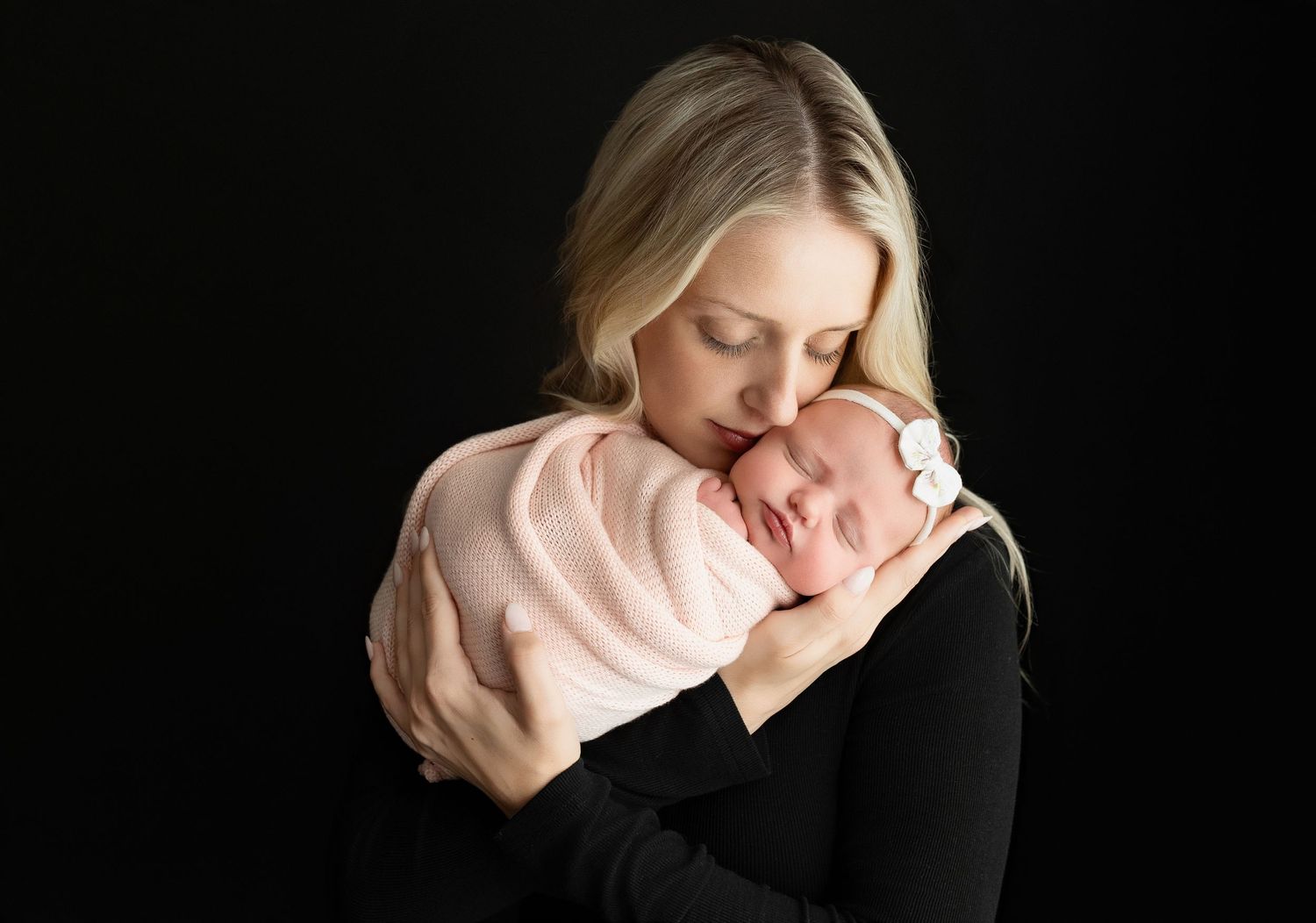 Mom is holding the newborn baby girl very tenderly.  - Greenville SC newborn photographer - Easley SC newborn photographer