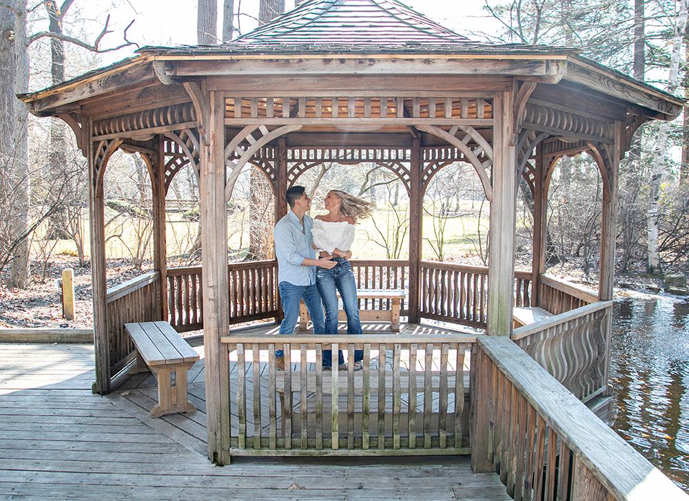 Wooden waterside gazebo with decorative trim photographed from multiple angles shows its scenic boardwalk setting.