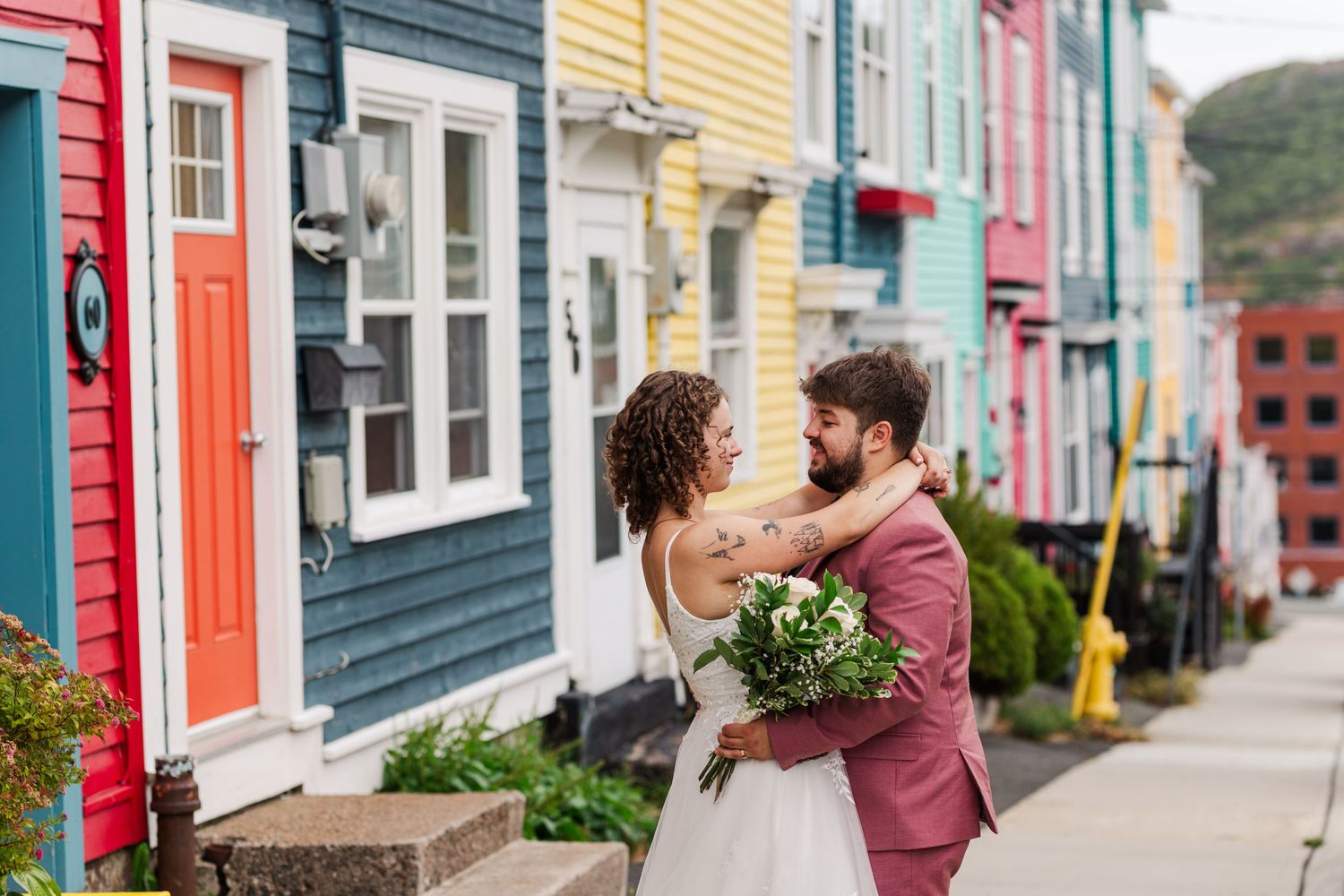 A colorful row of houses with bright facades lines a street in St. John's, Newfoundland.